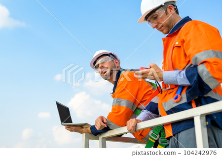 Renewable energy engineer working on wind turbine 104242976