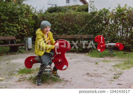 Funny cute happy baby playing on the playground. The emotion of happiness, fun, joy. Smile of a child. boy playing on the playground Funny cute happy baby playing on the playground. The emotion of happiness, fun, joy. Smile of a child. boy playing on the playground 104243017