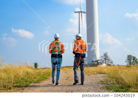 Renewable energy engineer working on wind turbine Renewable energy engineer working on wind turbine 104243019