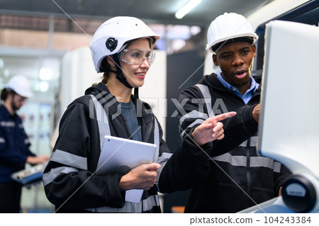 Engineer mechanician operating and controlling CNC machine Engineer mechanician operating and controlling CNC machine 104243384