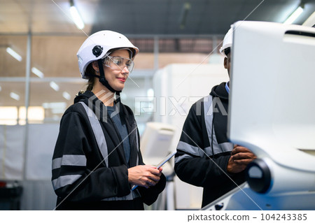 Engineer mechanician operating and controlling CNC machine 104243385