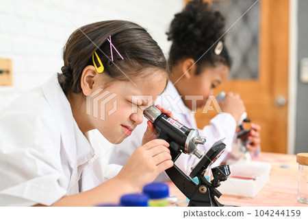 Child in classroom at school, Kid dressed science lab coat, Science concept Child in classroom at school, Kid dressed science lab coat, Science concept 104244159