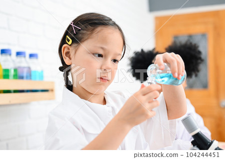 Child in classroom at school, Kid dressed science lab coat, Science concept Child in classroom at school, Kid dressed science lab coat, Science concept 104244451