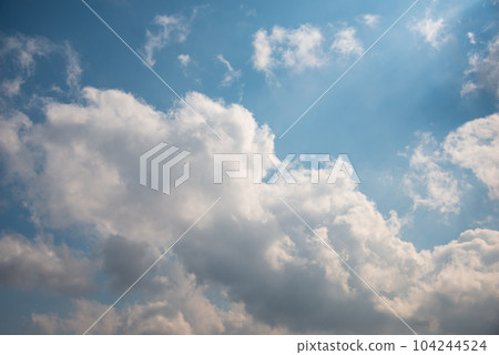 Scattered cloud clusters in a blue sky, blue sky background with white clouds. 104244524