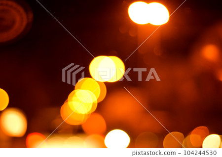 Blurred defocused lights at night. Abstract blur vehicle coming at night in the city. Blurred defocused lights at night. Abstract blur vehicle coming at night in the city. 104244530
