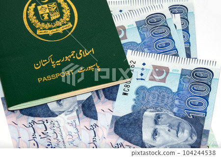 A Pakistani Passport on Currency notes in Pakistani Rupees 104244538