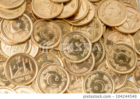 Stacks of gold coins of Pakistani currency symbolize wealth and prosperity Stacks of gold coins of Pakistani currency symbolize wealth and prosperity 104244548