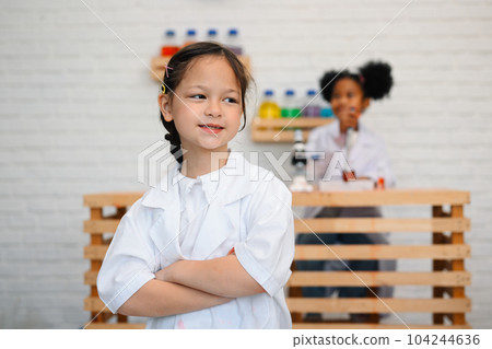 Child in classroom at school, Kid dressed science lab coat, Science concept 104244636