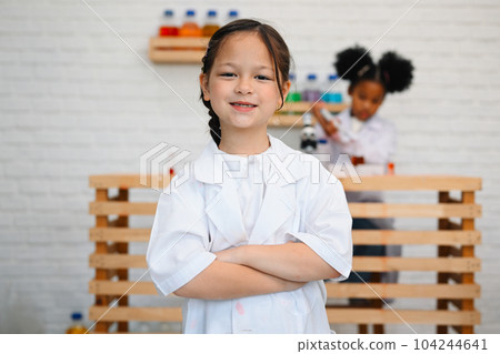 Child in classroom at school, Kid dressed science lab coat, Science concept Child in classroom at school, Kid dressed science lab coat, Science concept 104244641