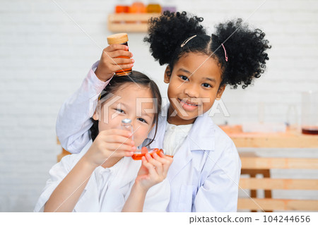 Child in classroom at school, Kid dressed science lab coat, Science concept Child in classroom at school, Kid dressed science lab coat, Science concept 104244656