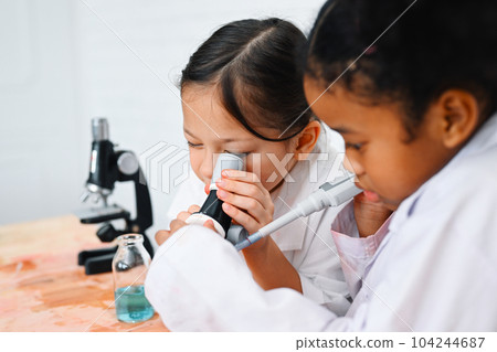 Child in classroom at school, Kid dressed science lab coat, Science concept Child in classroom at school, Kid dressed science lab coat, Science concept 104244687