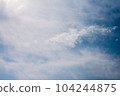 Scattered cloud clusters in a blue sky, blue sky background with white clouds. 104244875