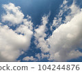 Scattered cloud clusters in a blue sky, blue sky background with white clouds. 104244876