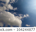 Scattered cloud clusters in a blue sky, blue sky background with white clouds. 104244877