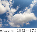 Scattered cloud clusters in a blue sky, blue sky background with white clouds. 104244878