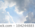 Scattered cloud clusters in a blue sky, blue sky background with white clouds. 104244883