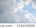 Scattered cloud clusters in a blue sky, blue sky background with white clouds. 104244886