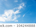 Scattered cloud clusters in a blue sky, blue sky background with white clouds. 104244888