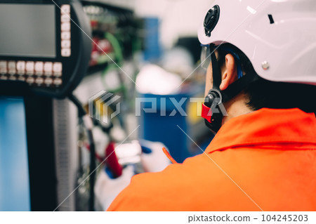 Professional engineer checking and repairing parts of machine 104245203