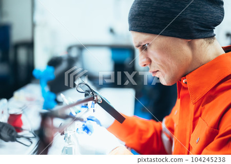 Professional engineer checking and repairing parts of machine Professional engineer checking and repairing parts of machine 104245238