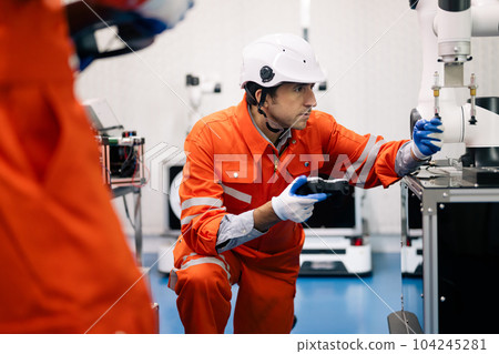 Professional technician holding robot controller checking machine Professional technician holding robot controller checking machine 104245281