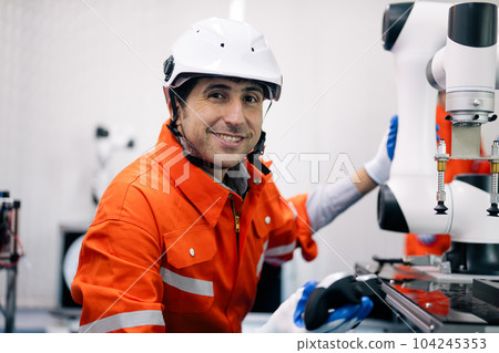 Professional technician holding robot controller checking machine 104245353