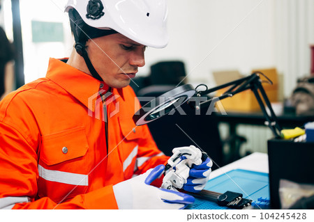 Professional engineer checking and repairing parts of robotic arm Professional engineer checking and repairing parts of robotic arm 104245428