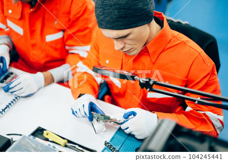 Professional engineer checking and repairing parts of robotic arm 104245441