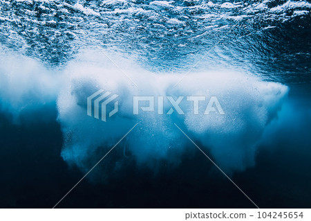 Ocean wave with foam underwater in clear water. Ocean wave with foam underwater in clear water. 104245654
