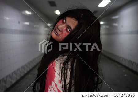 Scary woman in white dress with bloodstain after murder, Halloween concept 104245980