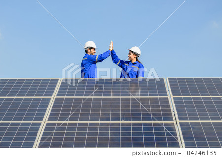 Technicians workers installing solar panels at solar cell farm Technicians workers installing solar panels at solar cell farm 104246135