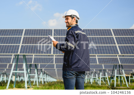 Technician worker installing solar panels at solar cell farm Technician worker installing solar panels at solar cell farm 104246136