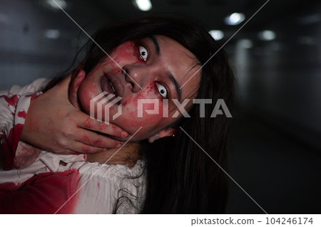Scary woman in white dress with bloodstain after murder, Halloween concept 104246174