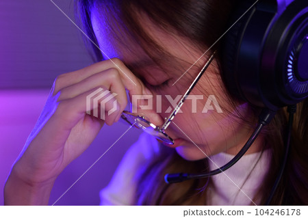 Female gamer having eye strain and headache after lose game close up Female gamer having eye strain and headache after lose game close up 104246178