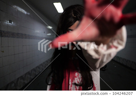 Scary woman in white dress with bloodstain after murder, Halloween concept Scary woman in white dress with bloodstain after murder, Halloween concept 104246207