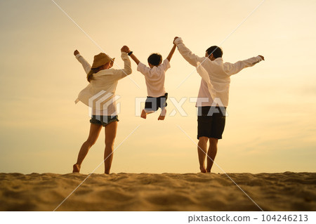 Happy family enjoying together on beach on holiday vacation 104246213