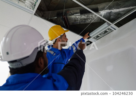 Engineers technicians with safety helmet working installing and checking system Engineers technicians with safety helmet working installing and checking system 104246230