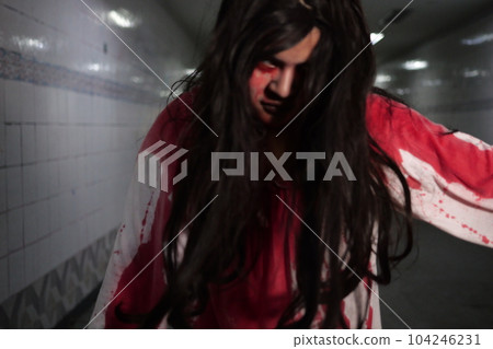 Scary woman in white dress with bloodstain after murder, Halloween concept 104246231