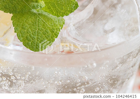Pour carbonated water into a rocks glass filled with mint and lemon A cool glass that bursts with carbonation Pour carbonated water into a rocks glass filled with mint and lemon A cool glass that bursts with carbonation 104246415