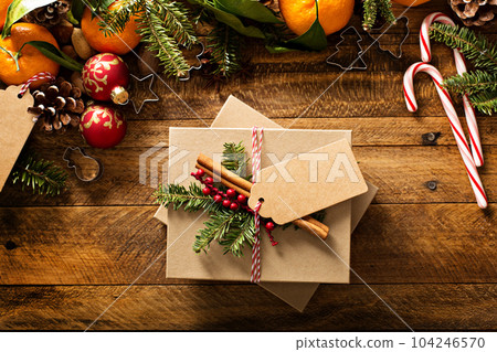 Christmas present with oranges, candy canes and decorations Christmas present with oranges, candy canes and decorations 104246570
