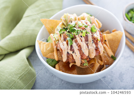 Poke bowl with fried wonton wrappers 104246593