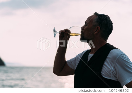 Man drinking wine glass on luxury yachts, Happy man enjoying summer travel Man drinking wine glass on luxury yachts, Happy man enjoying summer travel 104246802