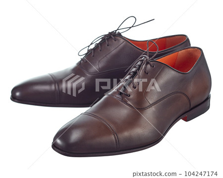 Beautiful pair of classic men's shoes made of high-quality brown leather, lace-up, with a leather sole, isolated on a white background. 104247174