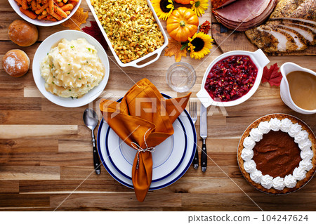 Thanksgiving table with turkey and sides Thanksgiving table with turkey and sides 104247624