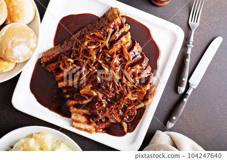 Sliced brisket with caramelized onions 104247640