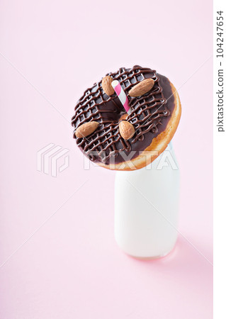 Chocolate almond donut with a bottle of milk 104247654