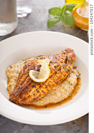 Grits with fried fish 104247817
