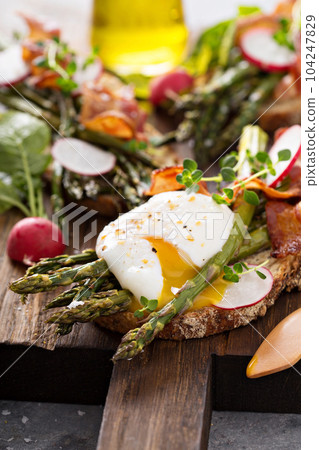 Asparagus and bacon bruschetta with poached egg Asparagus and bacon bruschetta with poached egg 104247829