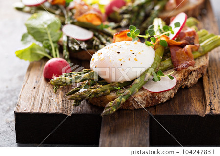 Asparagus and bacon bruschetta with poached egg Asparagus and bacon bruschetta with poached egg 104247831