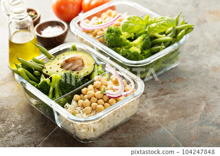 Vegan meal prep containers with cooked rice and chickpeas Vegan meal prep containers with cooked rice and chickpeas 104247848